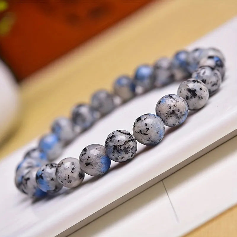 Handmade geometric bracelet made from blue K2 Azurite stone beads on a wrist.