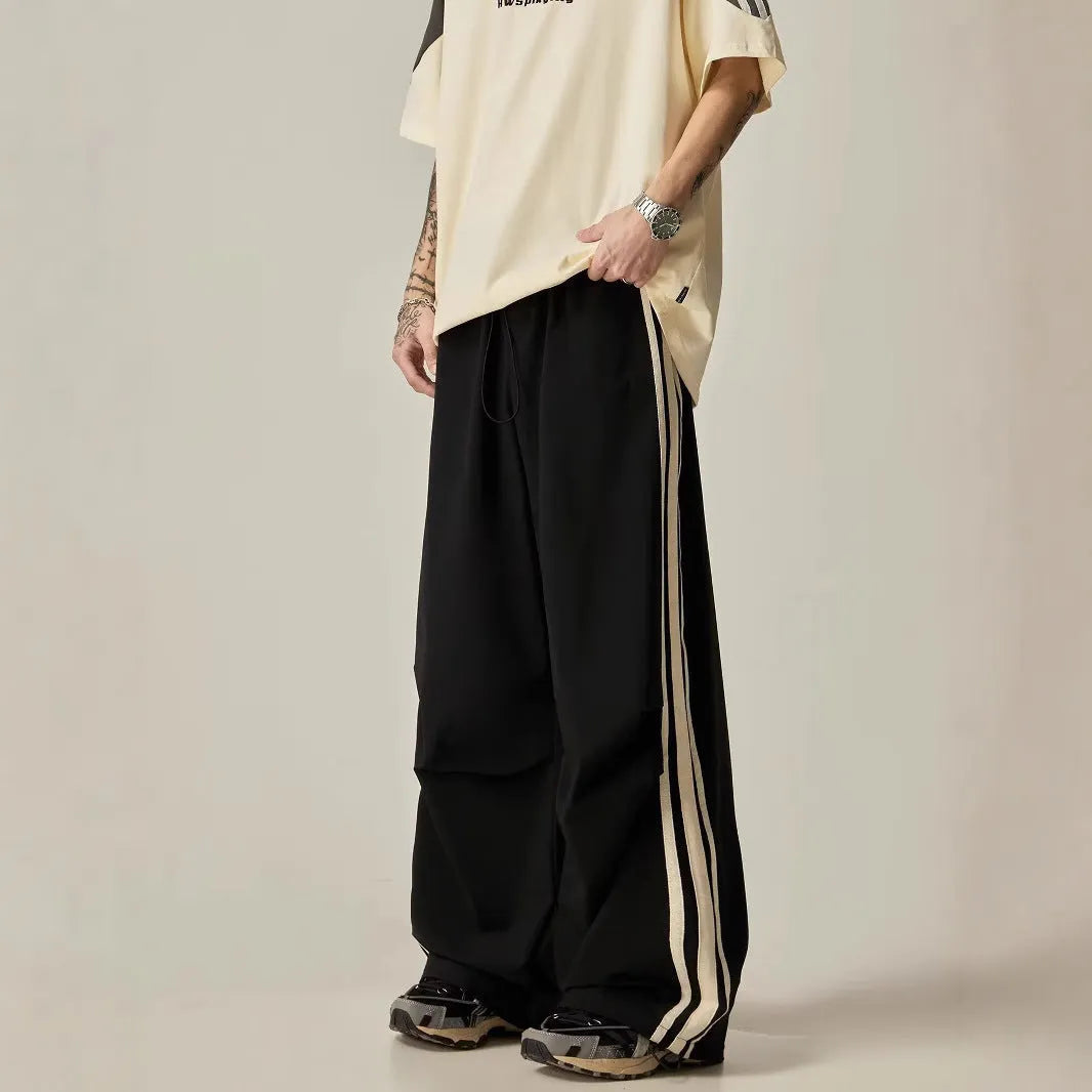 Black men's wide leg high-waist trousers with a straight-leg cut for summer casual wear.