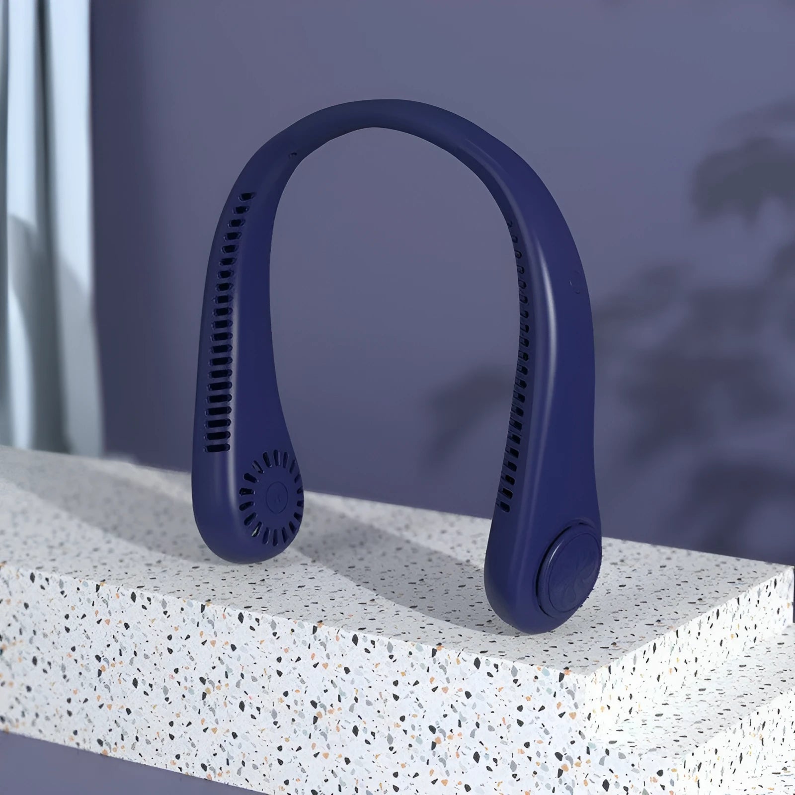 Blue portable bladeless neck fan hanging ergonomically, showing USB charging port and control button.