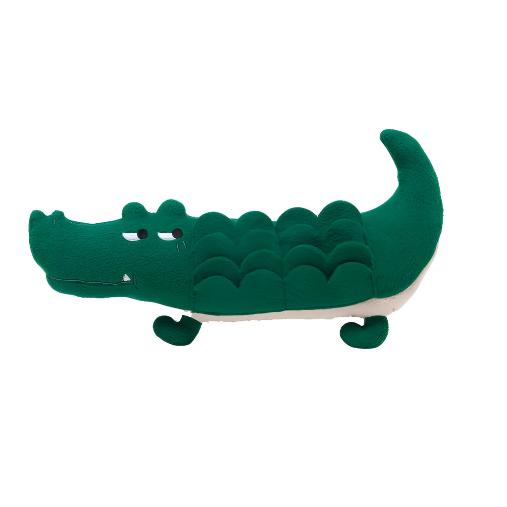 Green soft plush toy dog with floppy ears and embroidered face, lying on a white background.