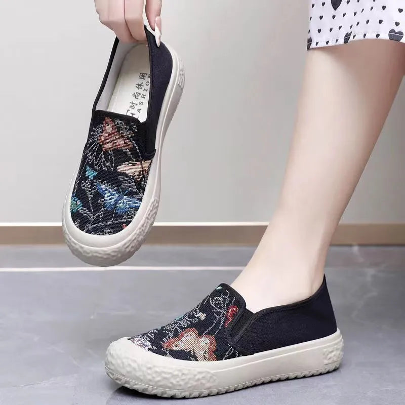 Old Beijing women's slip-on canvas shoes in black or white with a round toe and shallow cut.
