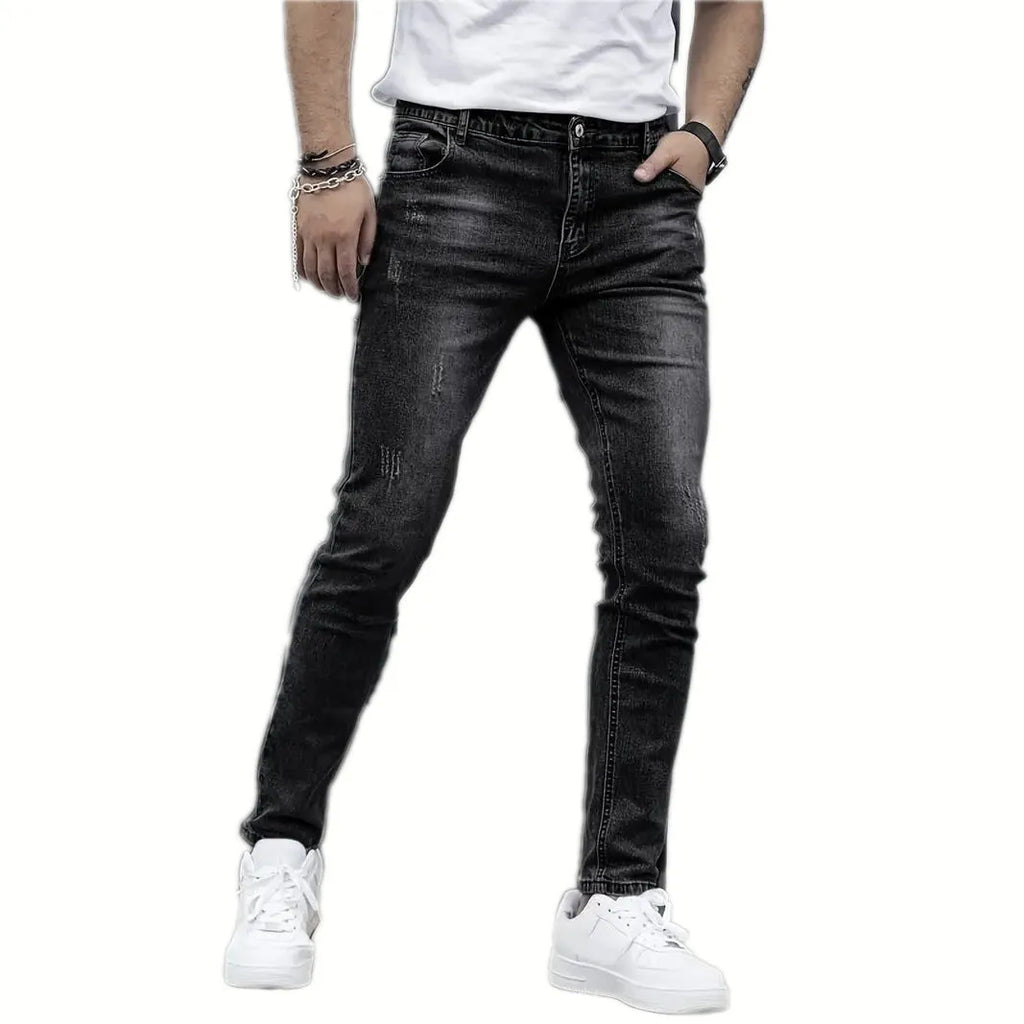Men's slim-fit stretch jeans in dark blue on a neutral background.