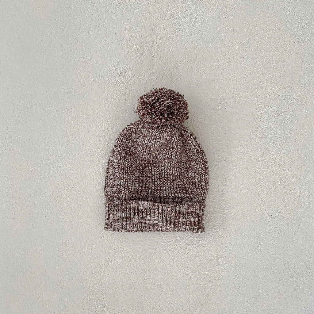 Dark brown knitted 3-piece set for infant girl with pullover blouse, pants, and fur ball hat