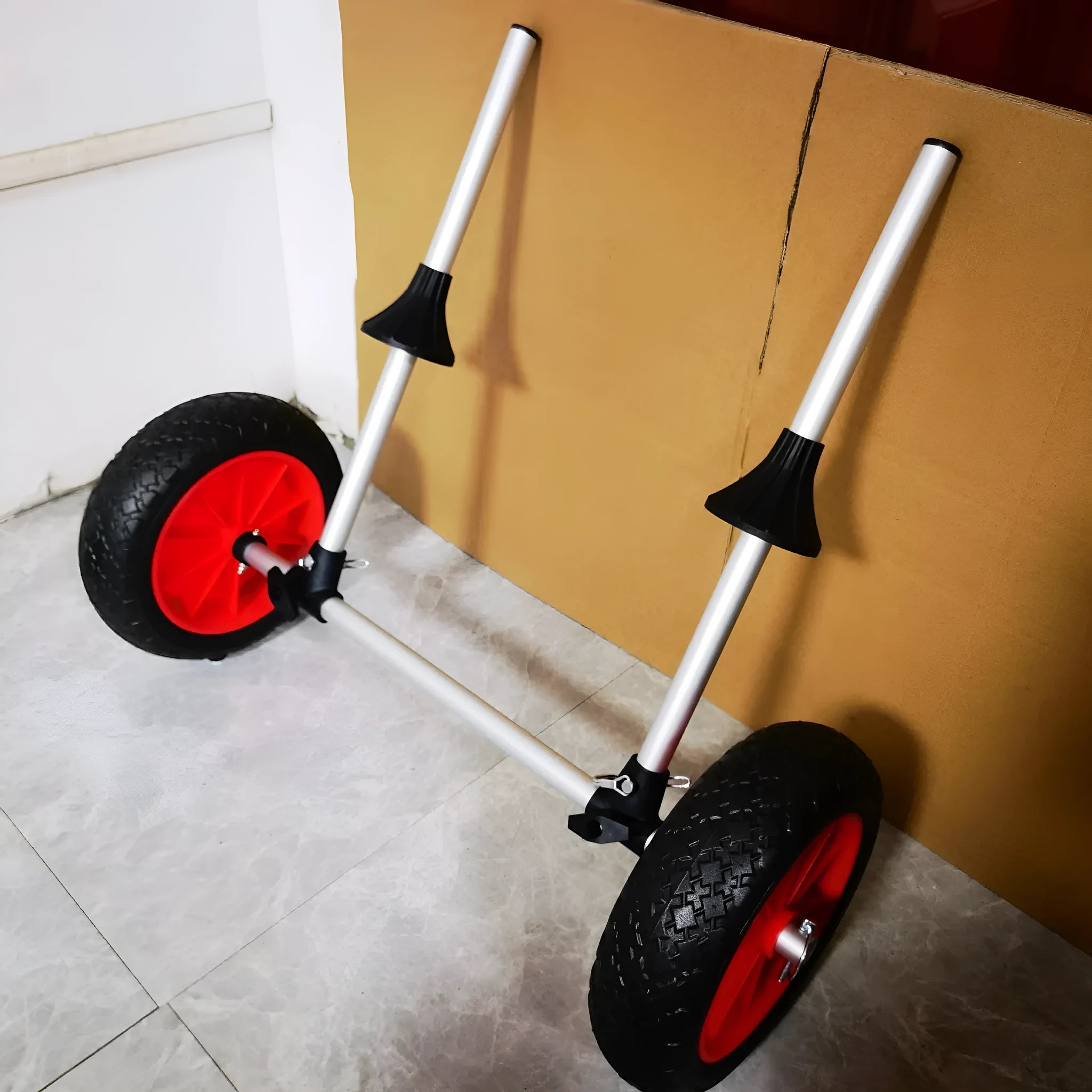 Foldable aluminium kayak cart with upright pole platform on a beach.