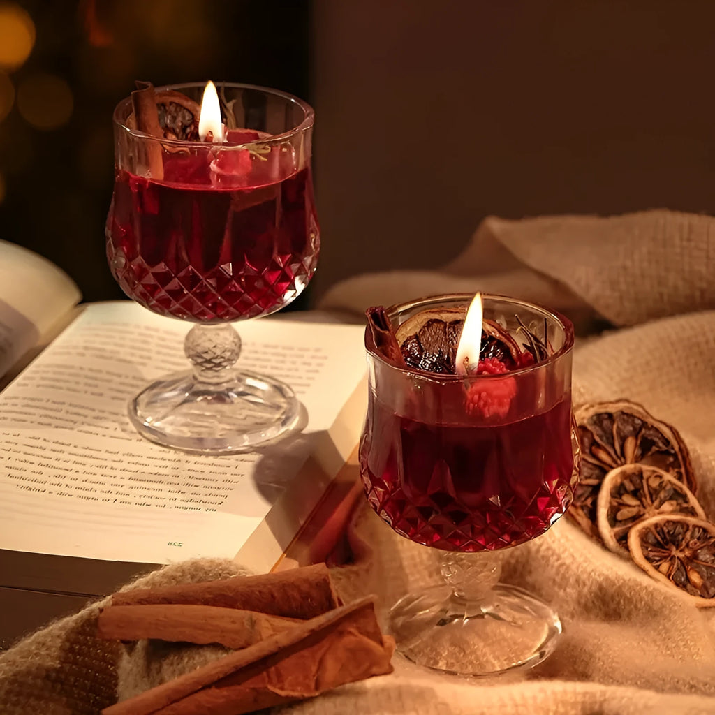 Clear glass wine goblet containing a scented candle with French mulled wine style