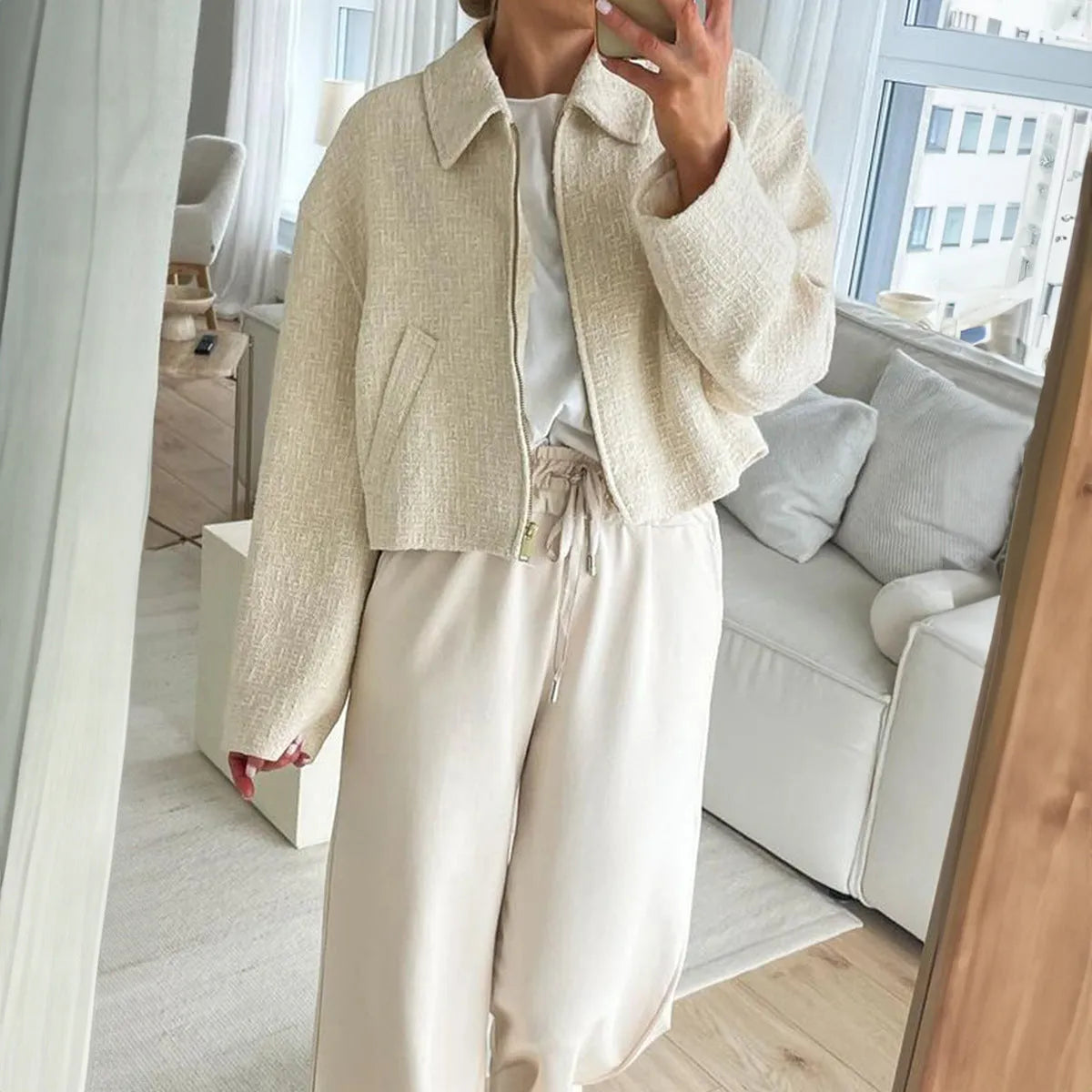 Women's apricot solid colour polyester long sleeve jacket, front view, on hanger