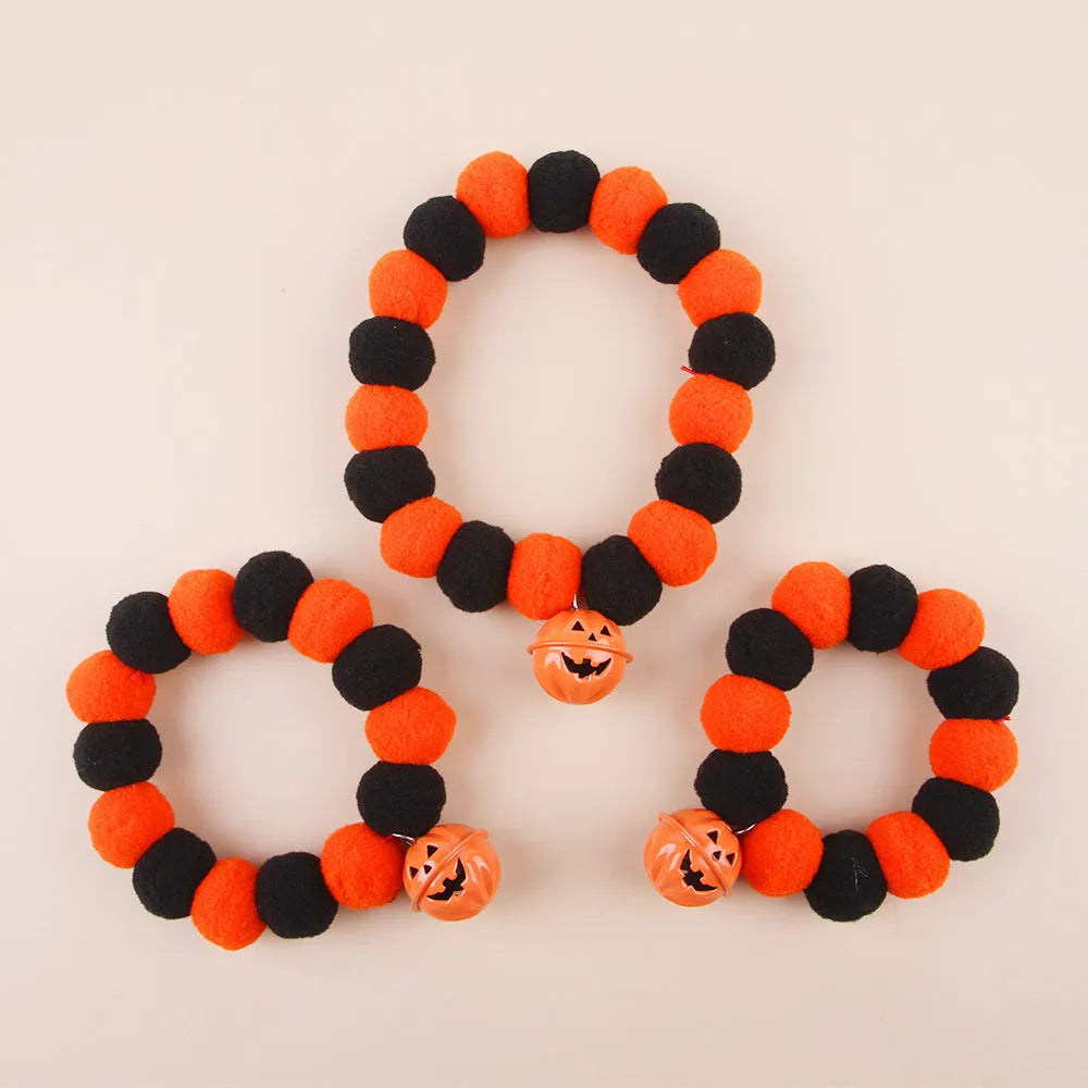 Adjustable orange plastic cat collar with a detailed Halloween pumpkin decoration.