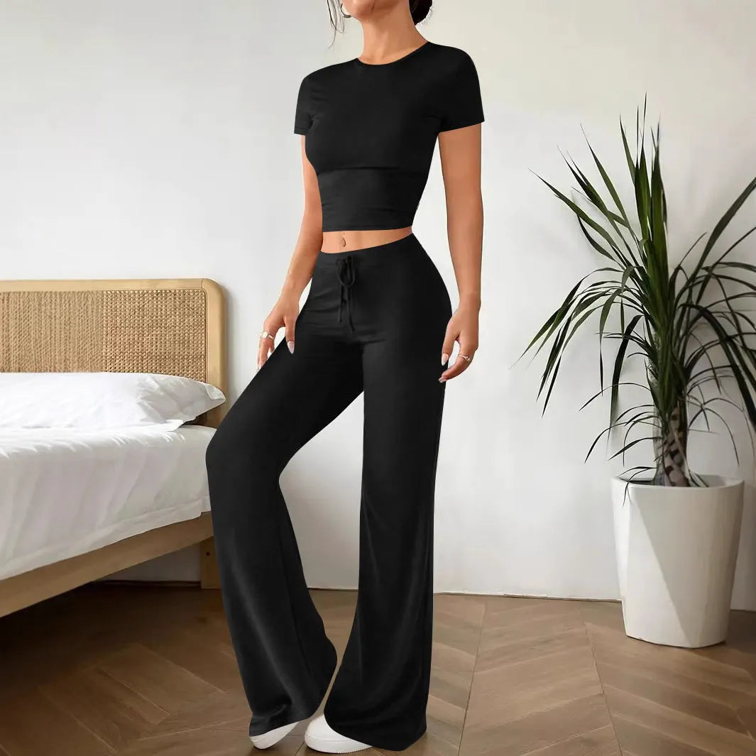 Black high waist trousers and short sleeve t-shirt co-ord suit set on a hanger.