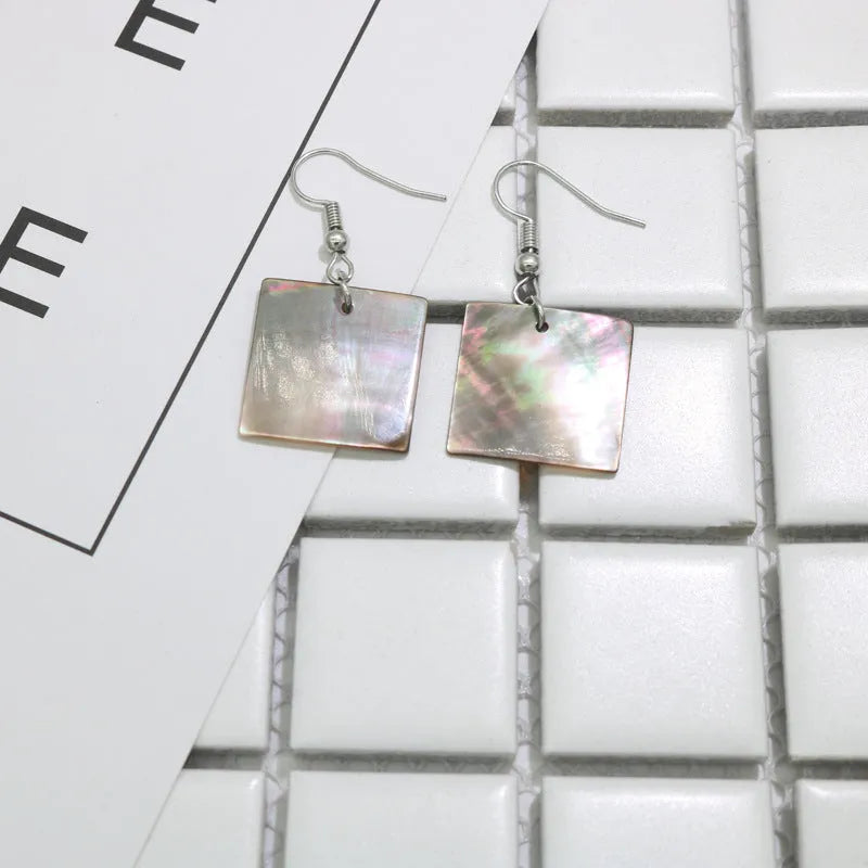 Women's shell geometric earrings with rectangular and square panther designs in natural shell material