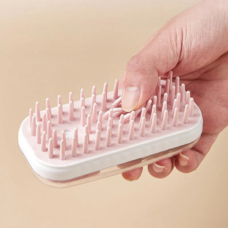 Grey silicone pet bath brush with flexible bristles and non-slip handle for washing dogs and cats.