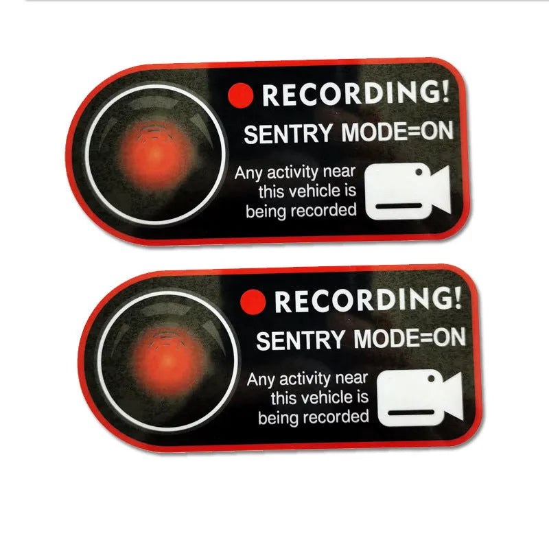 Pair of Tesla Sentry Mode warning stickers showing English text on PVC material