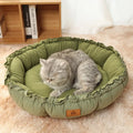 Grey reversible donut-shaped cat bed with raised rim, shown next to a green version of the same bed.