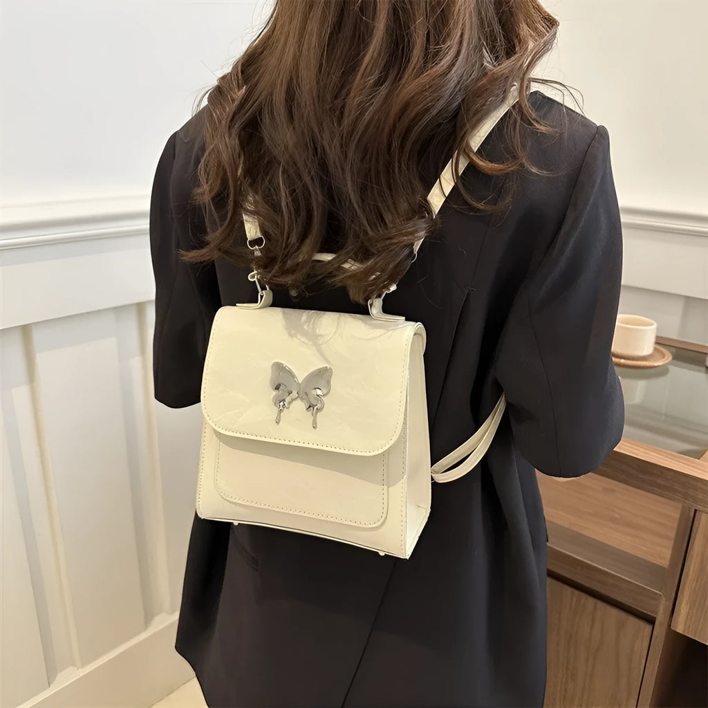 Women's preppy style PU backpack with hand-carry handle showing bow decoration and six colour options