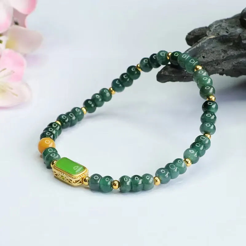 Close-up of a women's bracelet with blue water jade abacus beads in oval and round shapes on an adjustable band.