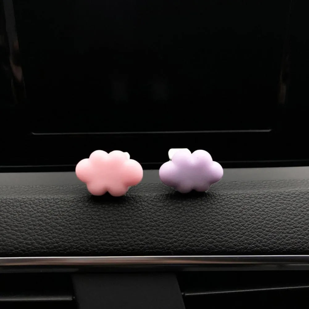 Resin Baiyun cartoon car fragrance clip in light green colour attached to a car air vent