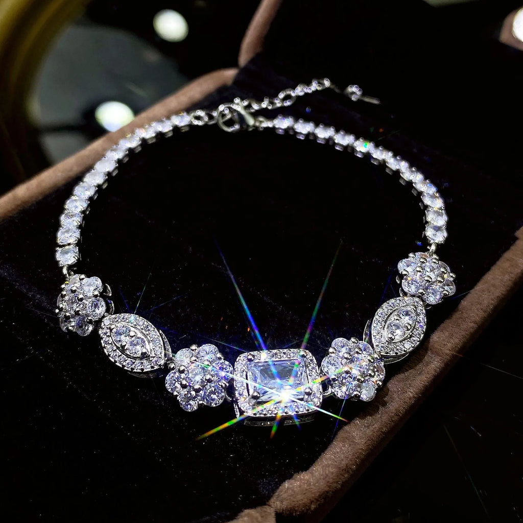 Women's silver-toned geometry bracelet with inlaid clear stones on a model's wrist.
