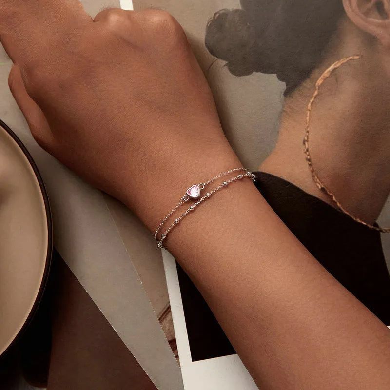 Sweet girlish heart-shaped 925 sterling silver bracelet on wrist, colour BSB152.