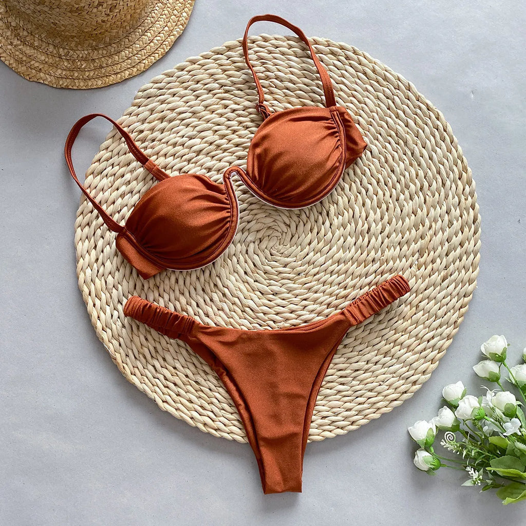 Women's black underwire bikini swimsuit set on a mannequin, showing sleeveless briefs style.