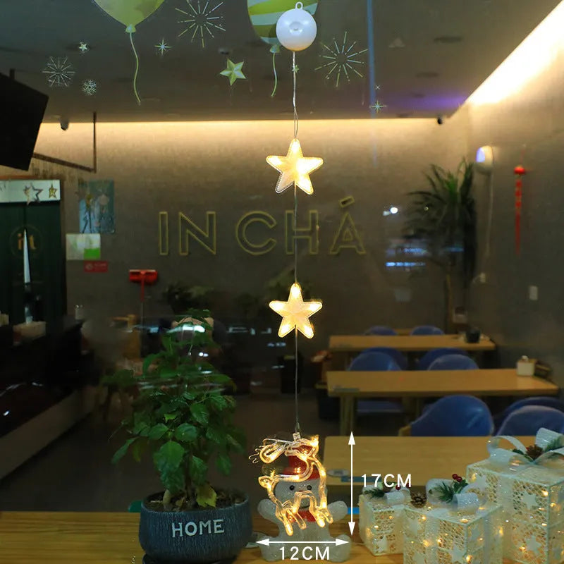 Set of three battery-powered LED Christmas pendant lights with suction cups, showing star, tree, and deer designs.
