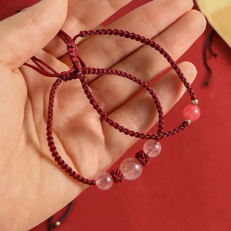 Woven red rope bracelet with natural strawberry quartz beads and alloy metal components