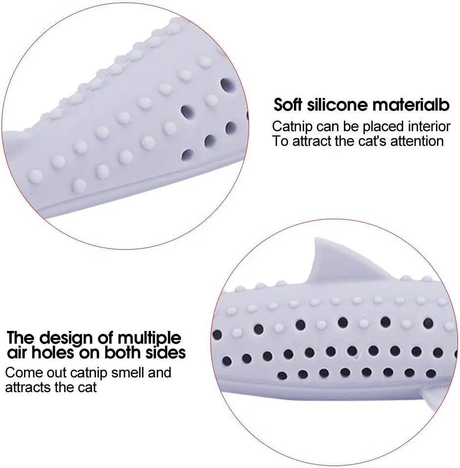Green dolphin-shaped silicone cat chew toy with side holes on a white background