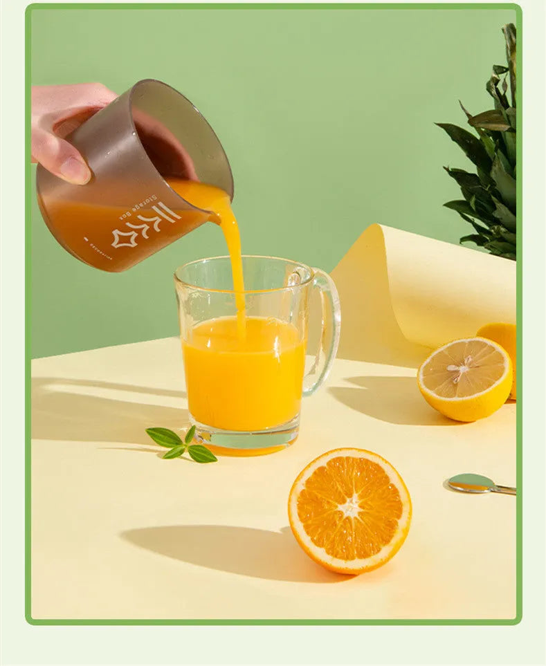 Green manual handheld citrus juicer with 400ml capacity on a kitchen counter