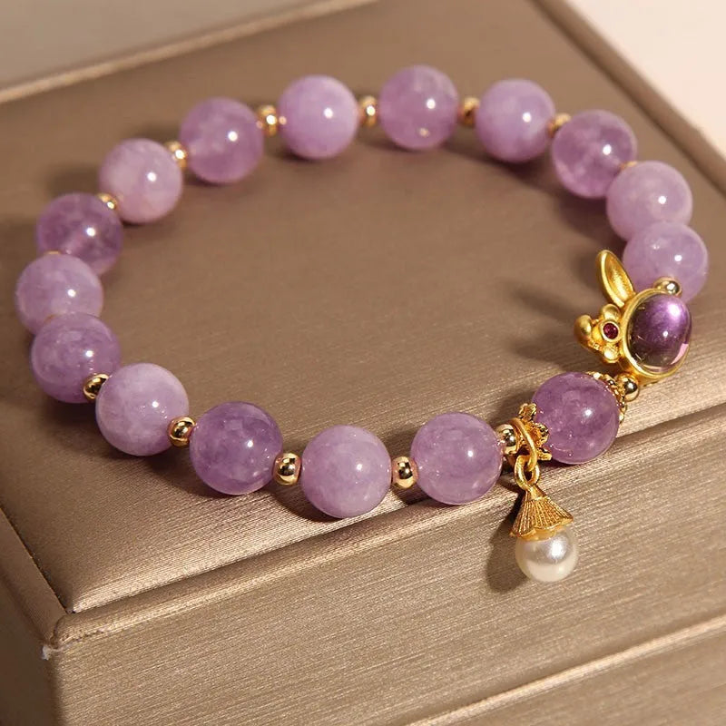 Purplish red mauve jade rabbit head charm on a clear crystal bracelet, Mori style design.