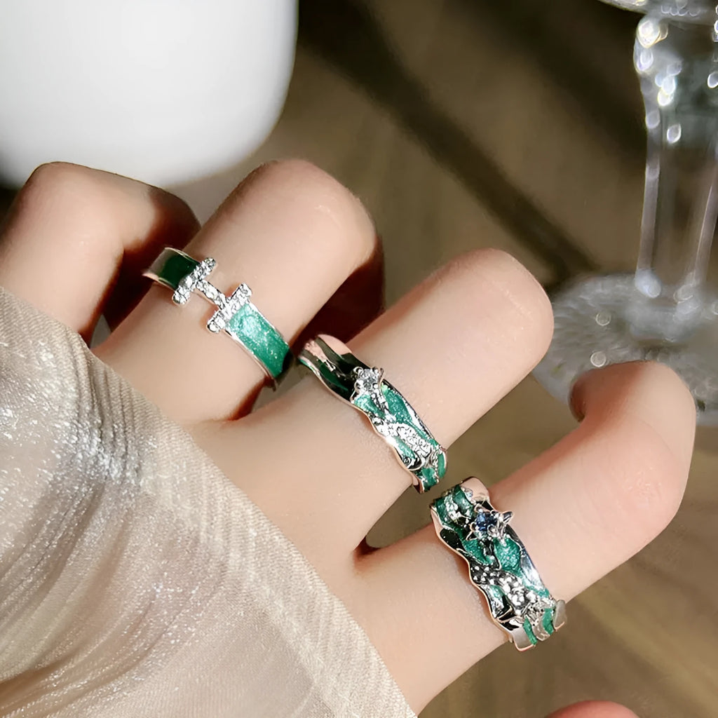 Mint green enamel asterism ring with copper base and eight-point star pattern on finger