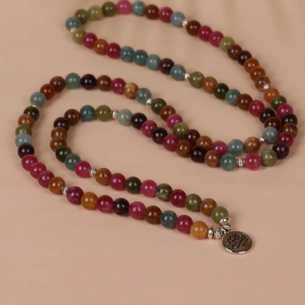 Close-up of a 108-bead alloy bracelet with a multi-layer lotus string design in a tourmaline colour.