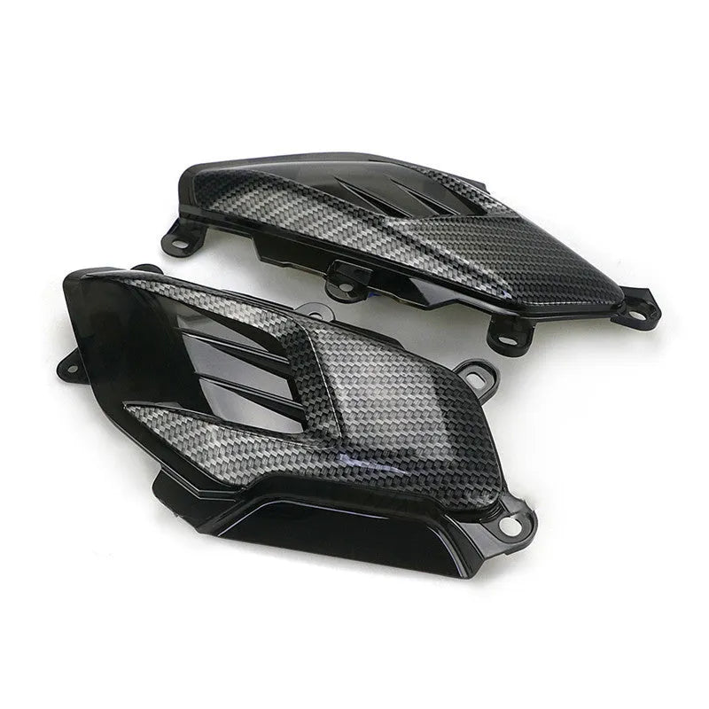 Pair of Yamaha NMAX side lamps with LED light and carbon fibre decoration on a black background.