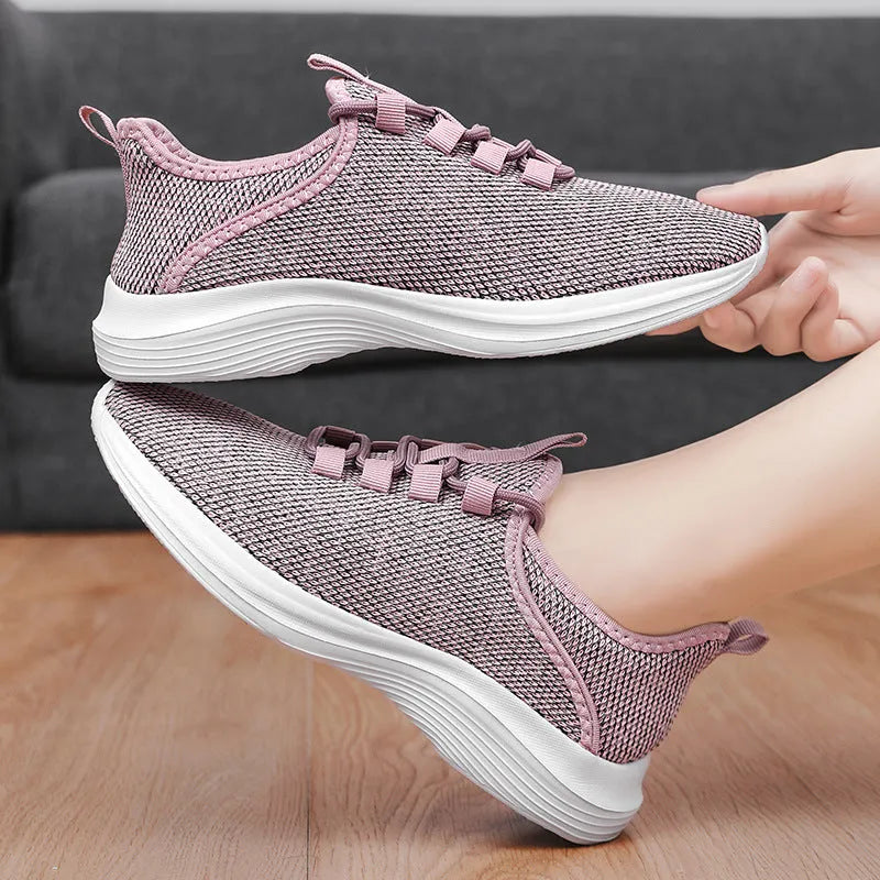 Women's low-top casual sneaker in grey with breathable mesh upper and lace-up front.