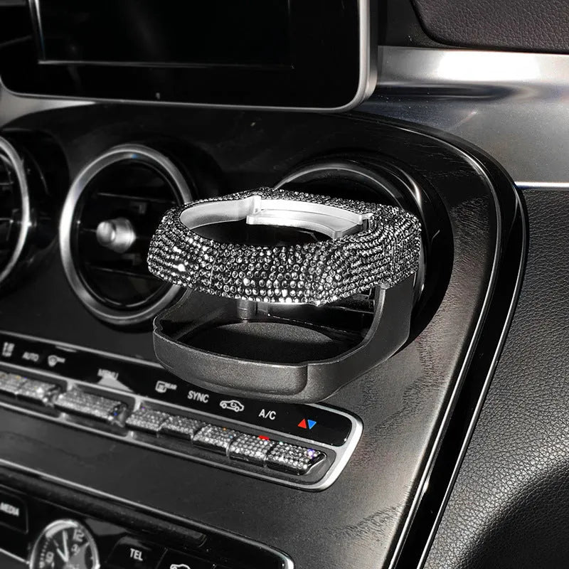 Diamond-decorated car cup holder bracket mounted on air vent in blue rhinestone finish