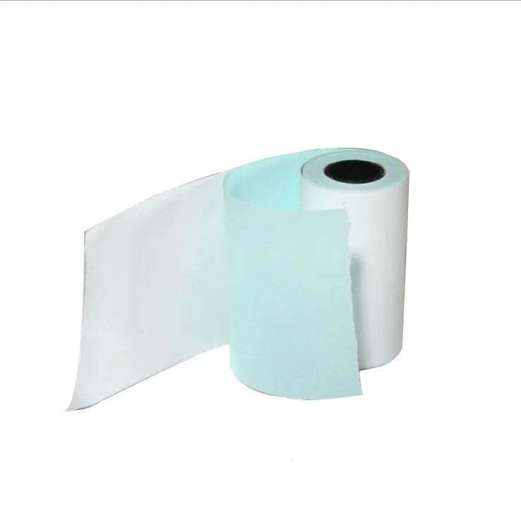 Bluetooth mini thermal photo printer in pink with USB cable and paper rolls on a white background