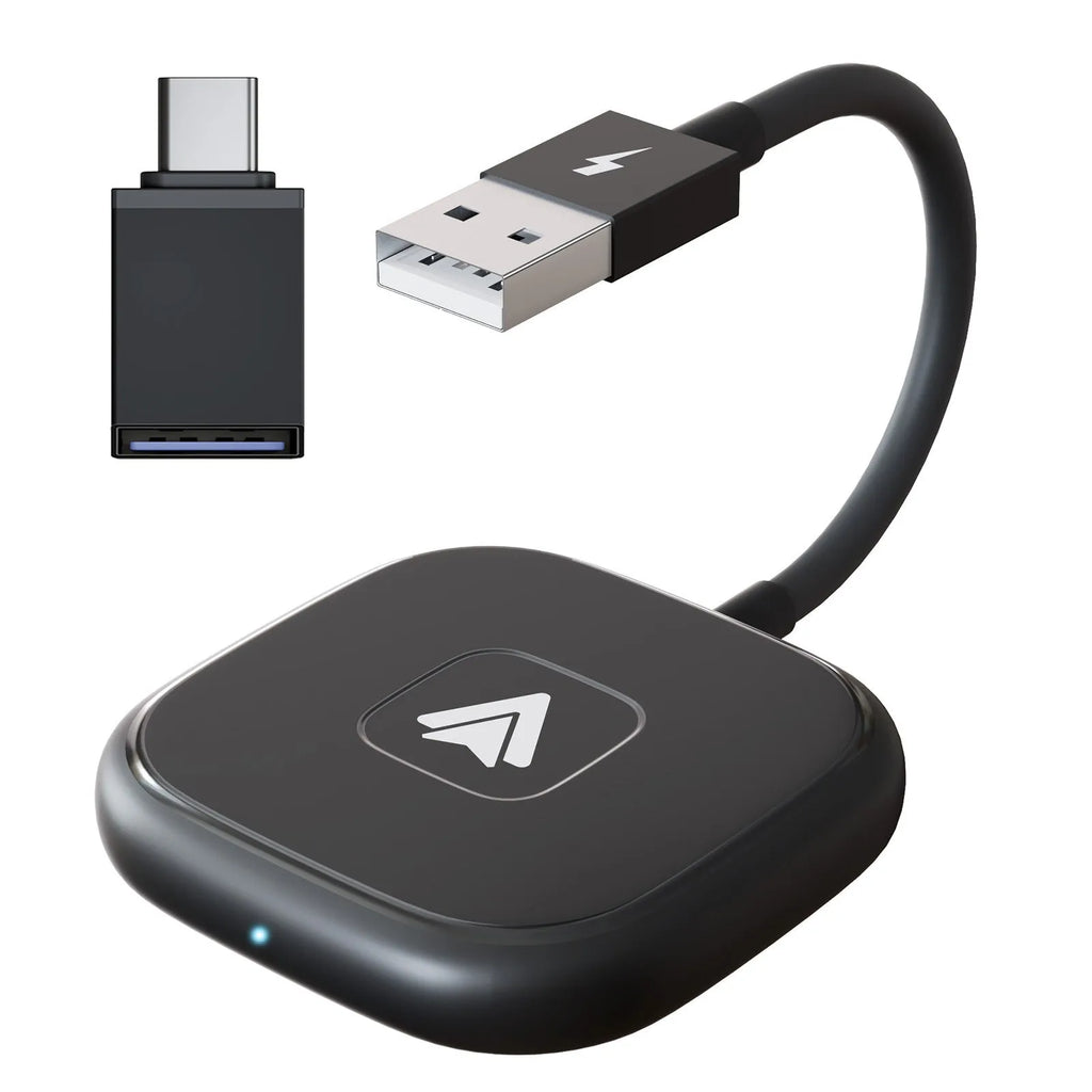 Black and white wireless Carplay adaptor for Android phones next to a car steering wheel