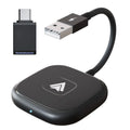 Black and white wireless Carplay adaptor for Android phones next to a car steering wheel