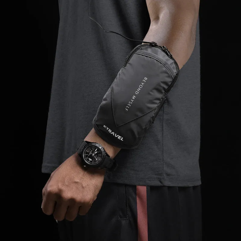 Black reflective running arm band wrapped around an arm, showing its strap and phone compartment.
