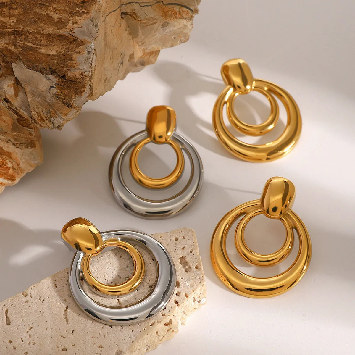 Gold geometric titanium steel stud earrings with double layer hollow round design