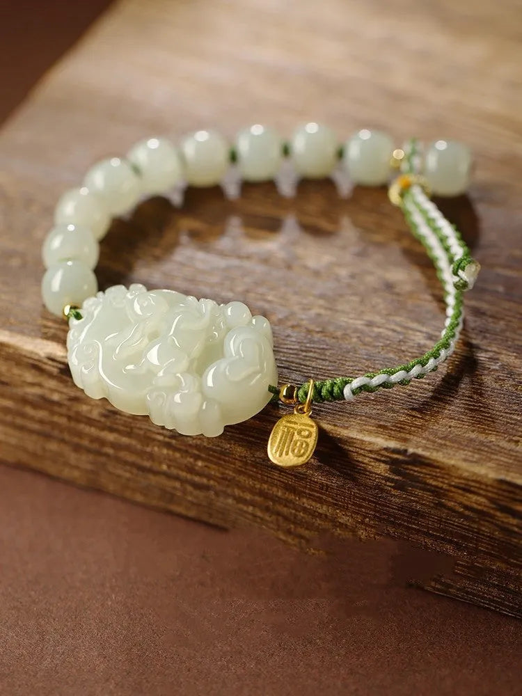 Hetian Jade Chinese zodiac bracelet on red cotton rope with S925 silver card for Year of Rabbit.