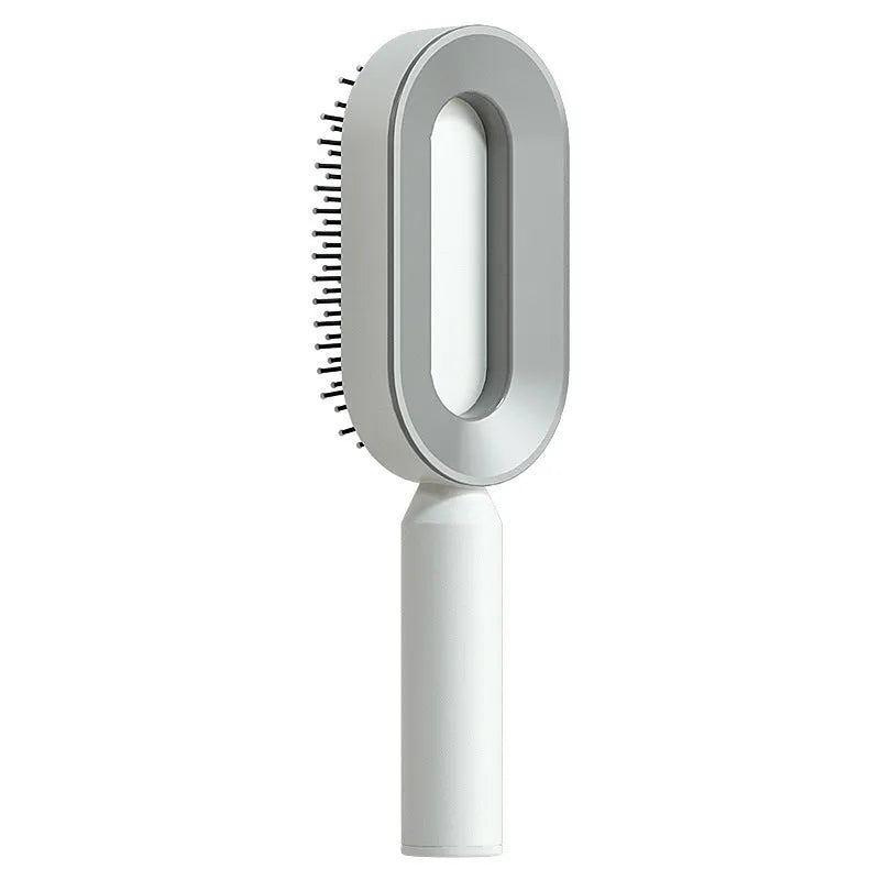 Self-cleaning hair brush with one-key button, air cushion base, and long bristles on a white background.