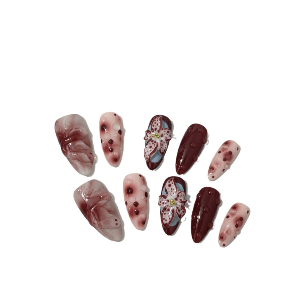 Almond-coloured hand-painted artificial nails with 3D carved rose and butterfly designs, shown in short and almond shapes.