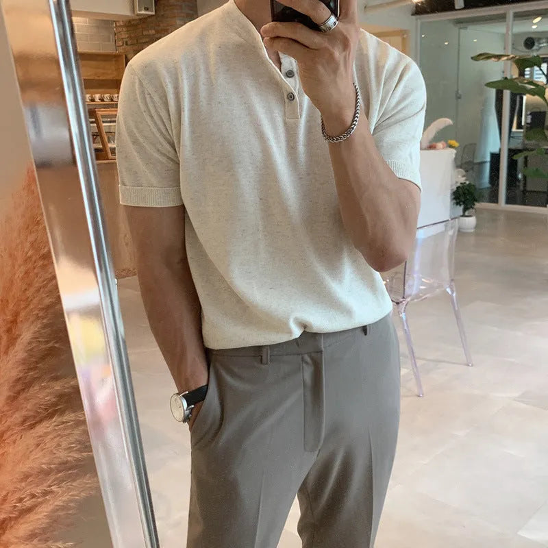 Man wearing a slim-fit black short-sleeved ice silk knitted pullover shirt.