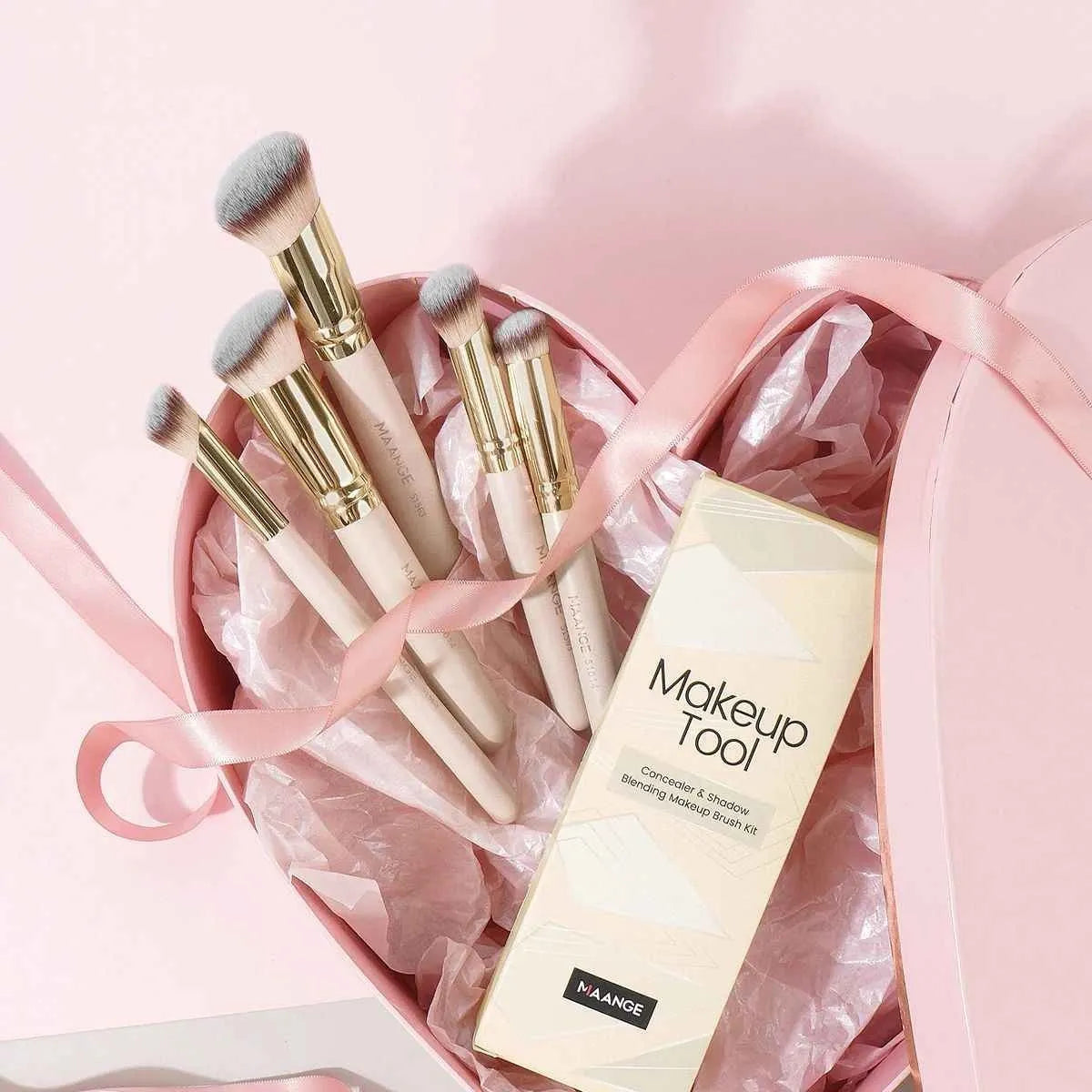 MAANGE set of five apricot-coloured makeup brushes with an angled blush brush on a grey background.