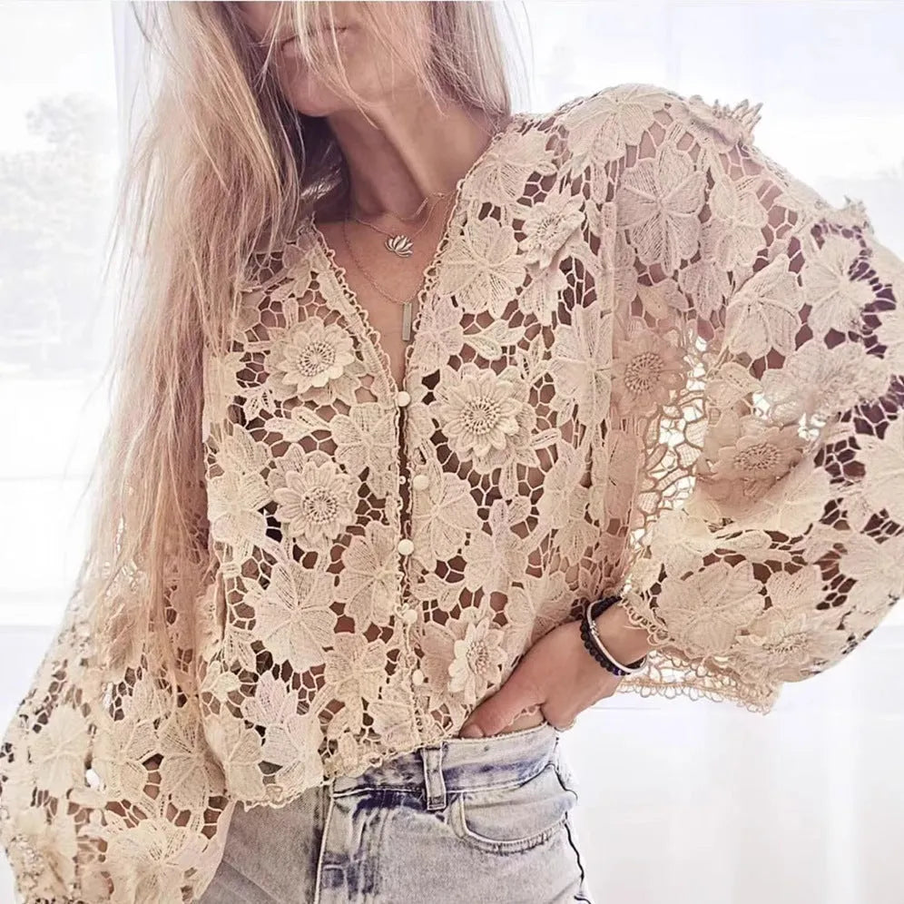 Black loose V-neck cardigan with white three-dimensional lace flowers on the front and hollow long sleeves.