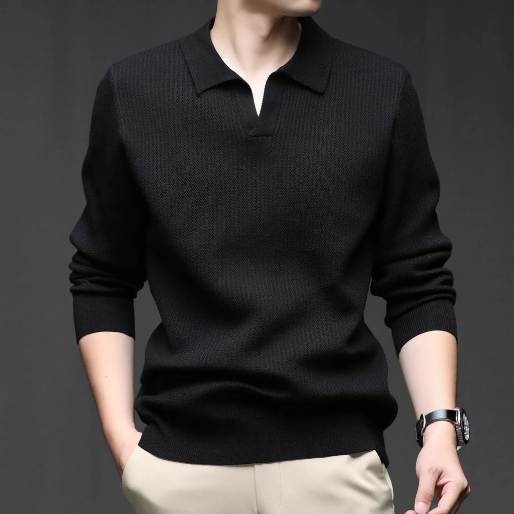 Man wearing a loose-fit green pullover sweater, a casual autumn garment.