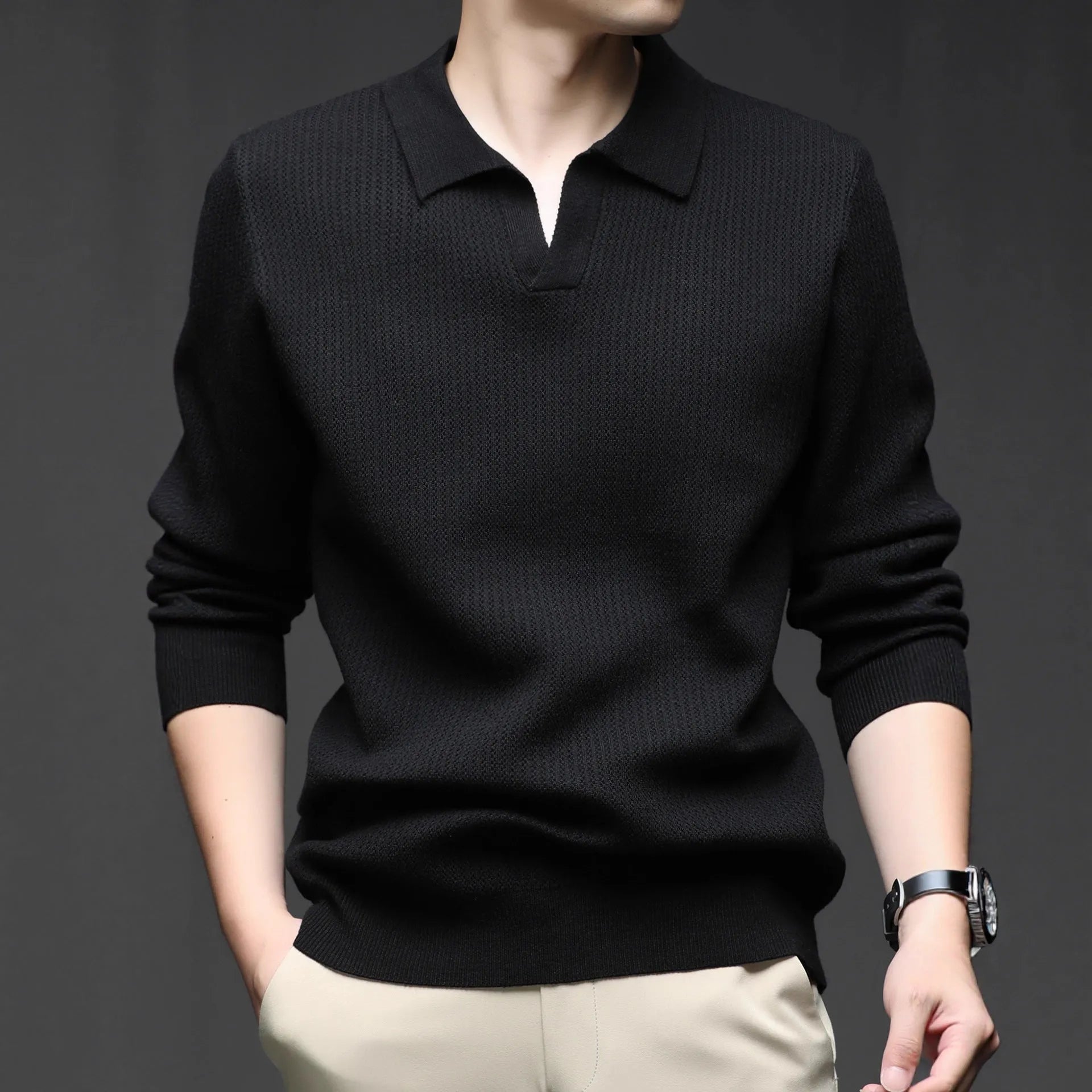 Man wearing a loose-fit green pullover sweater, a casual autumn garment.