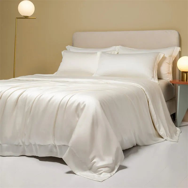 200 thread count Lenzing Tencel quilt cover and sheet set in Aurora Blue, laid on a bed.