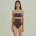 Brown women's one-piece swimsuit with a triangular style on a mannequin