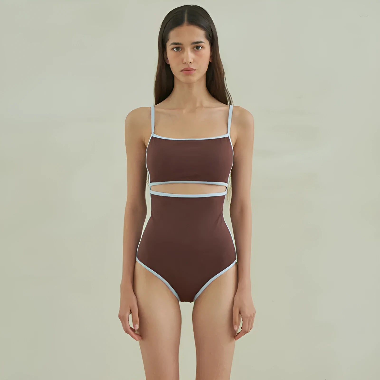 Brown women's one-piece swimsuit with a triangular style on a mannequin