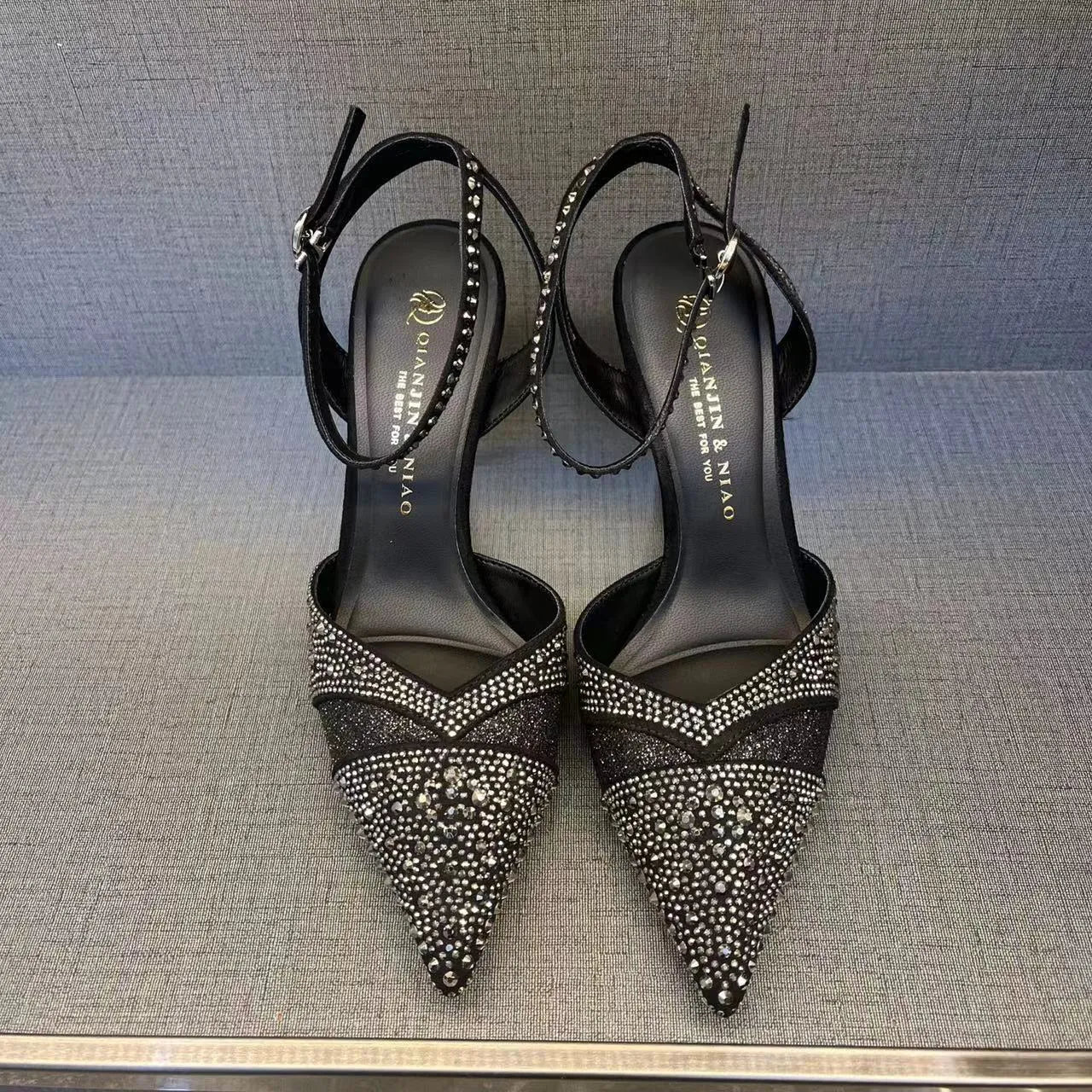 Women's black pointed-toe stiletto high heels with a hollow heel and red sole