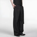 Black straight-leg trousers with a single pleat and adjustable waistband, made from a Tencel and cotton blend fabric.